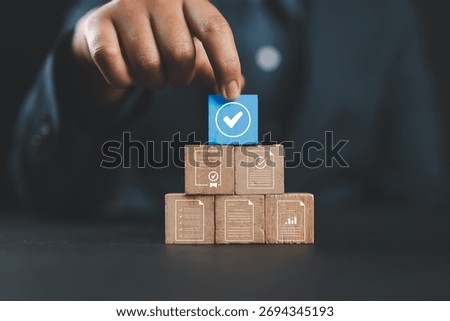 Document review process and quality control concept. Hand placing checkmark. Wooden blocks document icons, certified, document verification, business approval process, certificate management, audit,