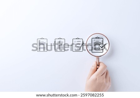 Document review and quality control process. A hand holding magnifying glass focuses on completed checklist in document workflow, symbolizing quality control, verification, and approval. Certificate,