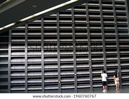 
Document shells in huge historical archive, young people interested in history, Memorial Hall of the Victims in Nanjing Massacre by Japanese Invaders, modern architecture					