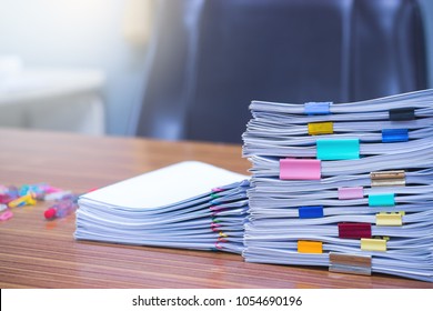 Document stacks arranged by various colored paper clips - Shutterstock ID 1054690196