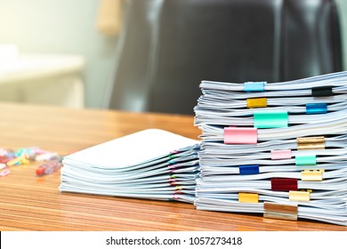 Document stacks arranged by various colored paper clips - Shutterstock ID 1057273418