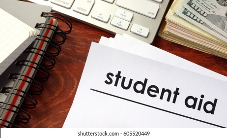 Document With Title Student Aid And Notebooks On A Table.