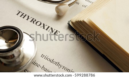Document with title Thyroxine on a table.
