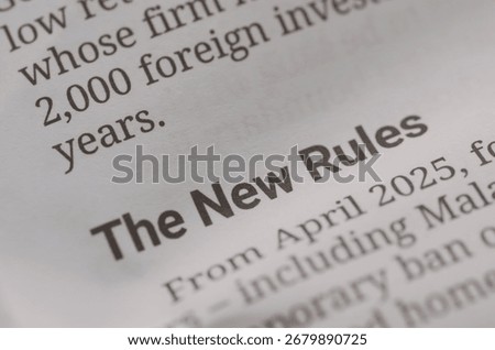 a document titled "The New Rules" visually represents the concept of updated laws, official guidelines, and significant policy shifts.