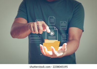 Document Transferring concept, File Sharing, Data transfer backup, Uploading documents from folder. Person hand showing and Open File folder with flying blank documents.