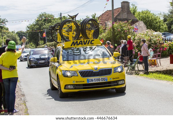 Documentary\
editorial. Hautteville Bocage, Manche, France - July 2 2016. First\
step of the French Cycle Tour, Cycle men and supporters along the\
road. Publicity cars before the\
cyclists