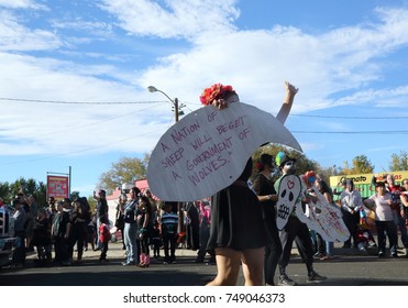 Documentary Editorial Image: Albuquerque, New Mexico - November 5, 2017: A woman holds a political sign with a quote by Edward R. Murrow at a Day of the Dead parade