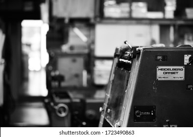 Documentary Photography Of A Commercial Printer: A Heidelberg Offset Printer And A Blurred Workshop