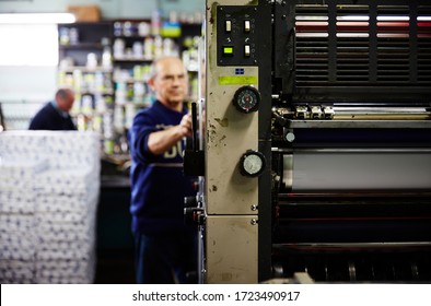 Documentary Photography Of A Commercial Printer: A Heidelberg Printer With Male Employees And The Interior Of A Print Workshop