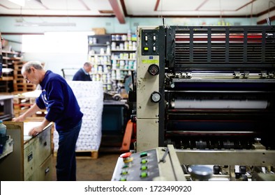 Documentary Photography Of A Commercial Printer: A Heidelberg Printer With Caucasian Male Employees Working