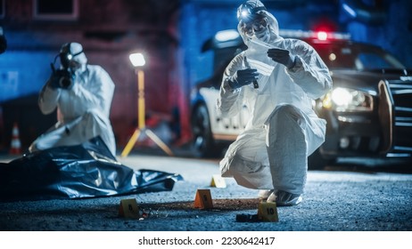 Documentary Shot: Forensics Unit Professionally Gathering Evidence From a Crime Scene and Working as a Team. Paramedics and Policemen are on Site. Expert Insuring Proper Packaging of Weapon