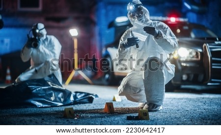 Documentary Shot: Forensics Unit Professionally Gathering Evidence From a Crime Scene and Working as a Team. Paramedics and Policemen are on Site. Expert Insuring Proper Packaging of Weapon