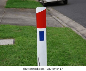 A documentary-style photograph of reflective guide posts installed beside a sealed transport corridor in suburban and regional Australia. Captured in natural daylight, the images showcase durable delineators positioned along grassy verges to improve visibility, define pavement edges and assist motorists with navigation during poor weather and low-light conditions. Their simple cylindrical design and reflective panels demonstrate an important element of traffic guidance and public safety infrastructure used throughout the country. The composition highlights practical engineering solutions that support everyday travel while documenting common features of Australia's transport system. Suitable for civil engineering references, government publications, traffic safety campaigns, educational resources, mapping projects, municipal planning documents, infrastructure reports, editorial articles and transport industry material. The authentic documentary perspective provides commercial and editorial value for projects exploring navigation, engineering standards, public works, regional connectivity, highway maintenance and essential community infrastructure.