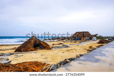 Documenting severe hurricane destruction across coastal buildings, beaches, and infrastructure after extreme storm events on Isla Cozumel island in Quintana Roo Mexico.