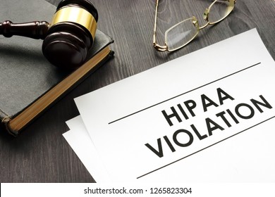 Documents about HIPAA violation and gavel in a court.