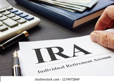 Documents About Individual Retirement Account IRA On A Desk.