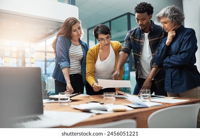 Documents, brainstorming and business people in meeting, creative agency or cooperation for ideas. Review, office and group with paperwork, collaboration for project and partnership with teamwork - Powered by Shutterstock