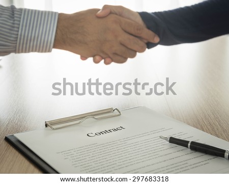 Documents contracting with partners are handshake background. select focus.