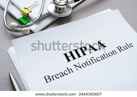 Documents HIPAA breach notification rule on table.