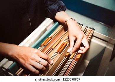 Documents in the office : Top view Bussinesswoman working hand searching Report file in drawer, filing cabinet, in office
 - Shutterstock ID 1223398957