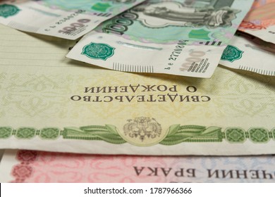 Documents And Paper Money Are On The Table Inscription Birth And Marriage Certificate