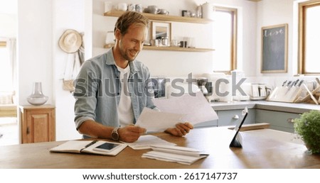 Documents, tablet and man in kitchen planning for debt, mortgage or tax payments in home. Paperwork, digital technology and male person with credit application, savings or monthly budget in house.