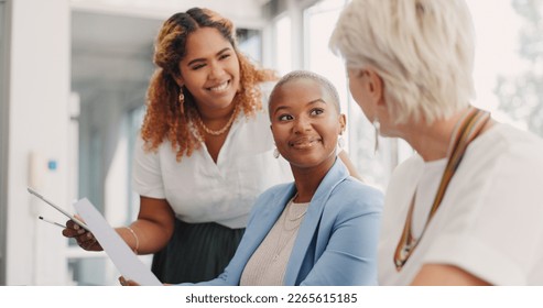 Documents, team work or business women in a meeting working on kpi data analytics or financial budget of a company. Portfolio, question or senior manager helping or talking to employee with paperwork - Powered by Shutterstock