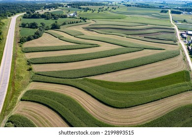Dodgeville, Wisconsin, USA, 08-31-2022: Contoured Farming is the practice of tilling sloped land along lines of elevation in order to conserve rainwater and reduce soil losses from surface erosion. - Shutterstock ID 2199893515