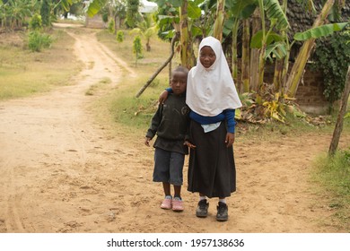 Dodoma, Tanzania. 08-18-2019. A black girl is hugging her small brother at the school premises after finishes lunch in a rural area of Tanzania.