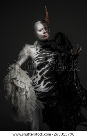Dody art demon woman isolated on dark grey