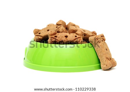 dog biscuit bone cookies in a bowl isolated on a white background