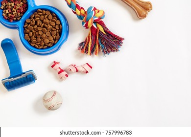 Dog Care Items, Isolated On White Background. Dry Pet Food In Bowl, Toy And Bones. Top View