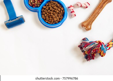 Dog Care Items, Isolated On White Background. Dry Pet Food In Bowl, Toy And Bones. Top View