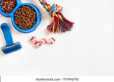 Dog Care Items, Isolated On White Background. Dry Pet Food In Bowl, Toy And Bones. Top View