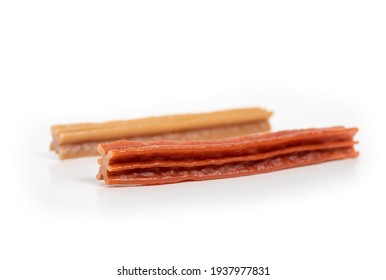 Dog dental chew sticks, perspective view. Two vegetarian and grain free dog treat sticks for stronger teeth, better gums and breath. Dental health treats for dogs. Isolated on white. Selective focus. 
