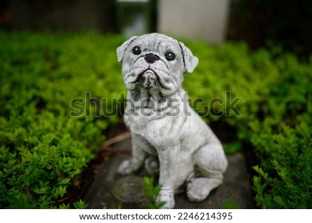 a dog figure bravely guarding a grave in a cemetery