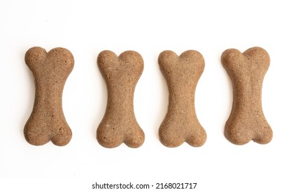 Dog Food Biscuit Shape Bone Isolated On White Background. Four Blank Snack Treat In A Row, Copy Space