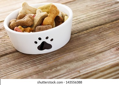 Dog food in a bowl on wooden table - Powered by Shutterstock