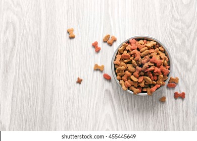 Dog Food In Bowl On Wooden Table