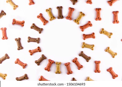 Dog food pattern made with dry snacks in shape of bones. Word dog in wooden tiles. Funny flat lay texture. Home pets, animals feeding. Special diet, training supply. Top view background.