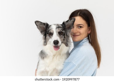 The Dog Jumped In And Is Sitting With Its Owner In Her Arms. Young Adult Girl. Border Collie Dog In Shades Of White And Black, And Long And Fine Hair. An Excellent Herding Dog.