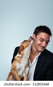 Dog Kissing His Owner - Young Business Man Have Fun With His Dog