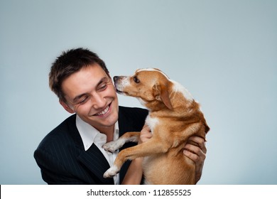 Dog Kissing His Owner - Young Business Man Have Fun With His Dog