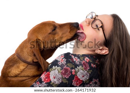 Dog licking a young woman 