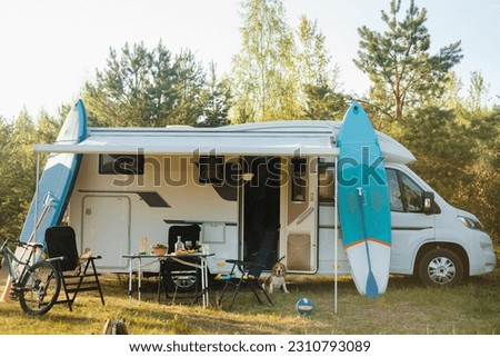 Similar – Women resting and talking lying in tent over car