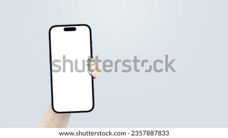 Dog paw holding smartphone mock up on isolated background. Smartphone, creative idea. Funny animal shows the phone
