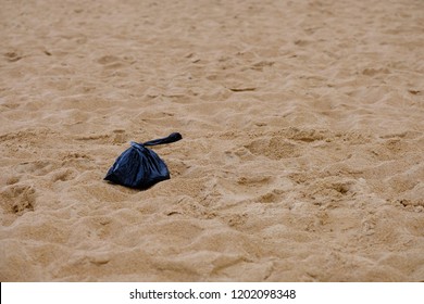 Dog poo bag on beach 