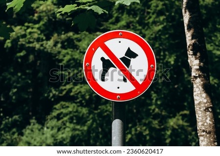 Dog prohibition sign, with tree foliage background, Bavaria, Germany