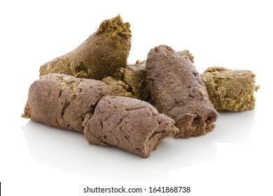 Dog shit. Pile of dog excrements on white bg. Isolated on white background with shadow reflection. With clipping path. With vector path. Dog feces, studio shot. Closeup shot. Cock of dog's turds. 