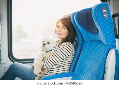 Dog Traveling By Train With His Owner